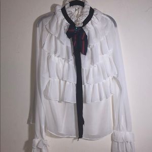 Ruffle blouse with brooch